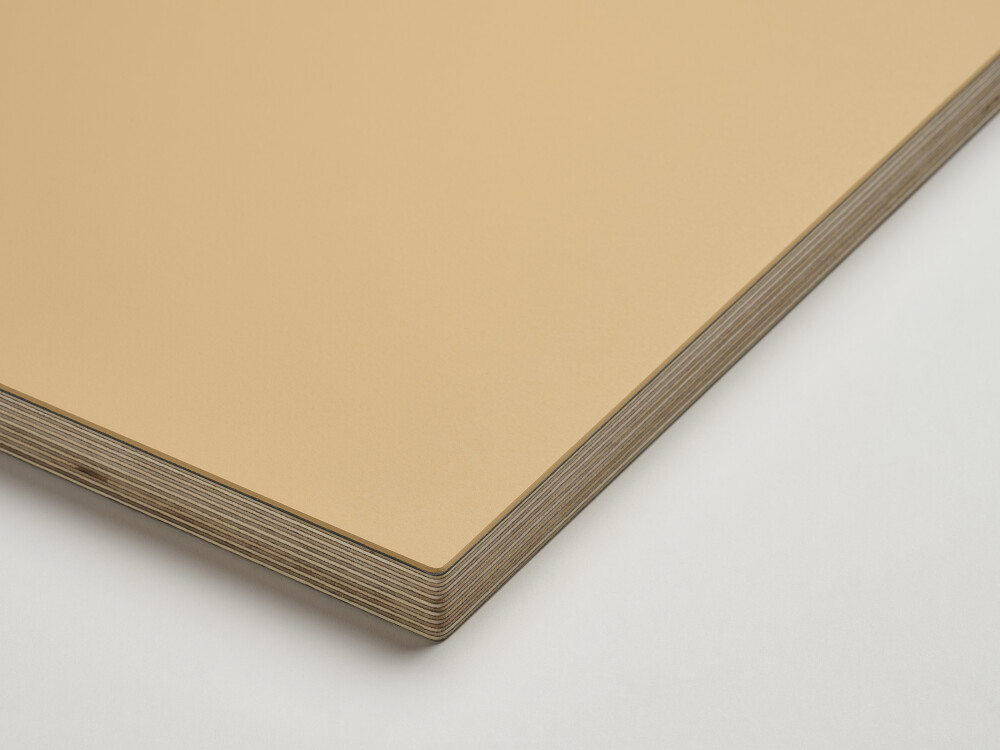 Fist table top with matt linoleum surface in clay and visible 2 cm multiplex edge made of solid birch – close-up view.
