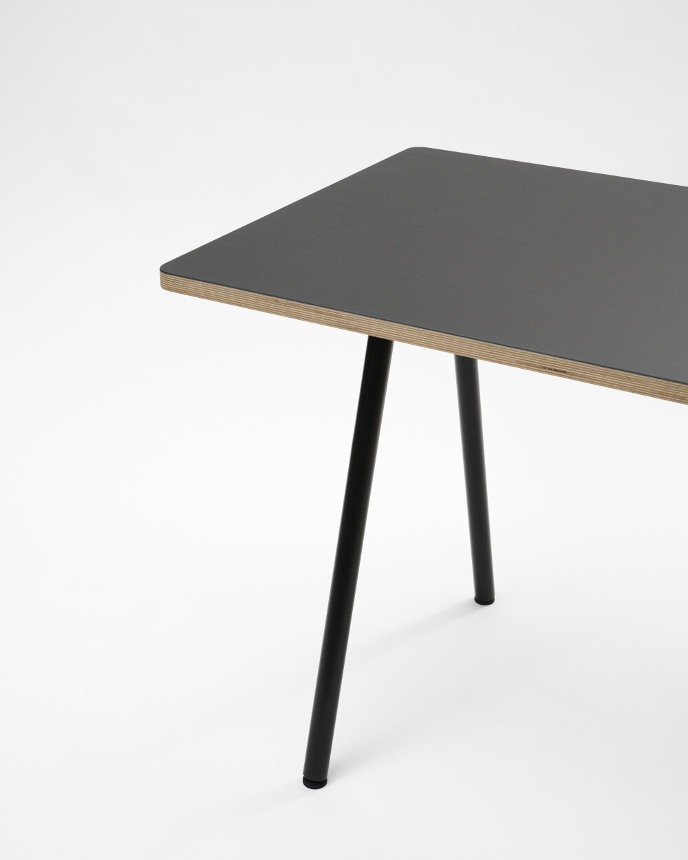Round DIN PLUS table leg by Faust, made of black powder-coated metal with linoleum tabletop against a white background.