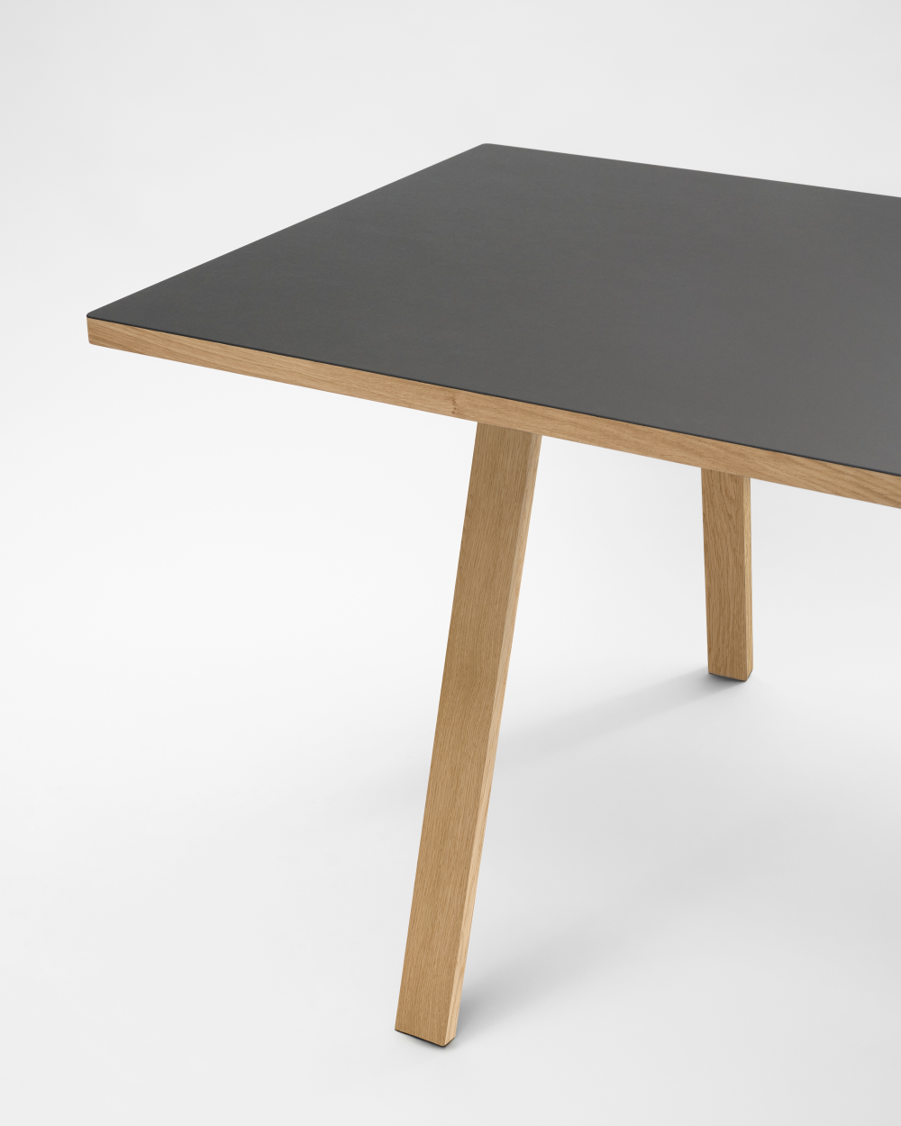 Rectangular DIN PLUS table leg by Faust, made of oak, and linoleum tabletop against a white background.
