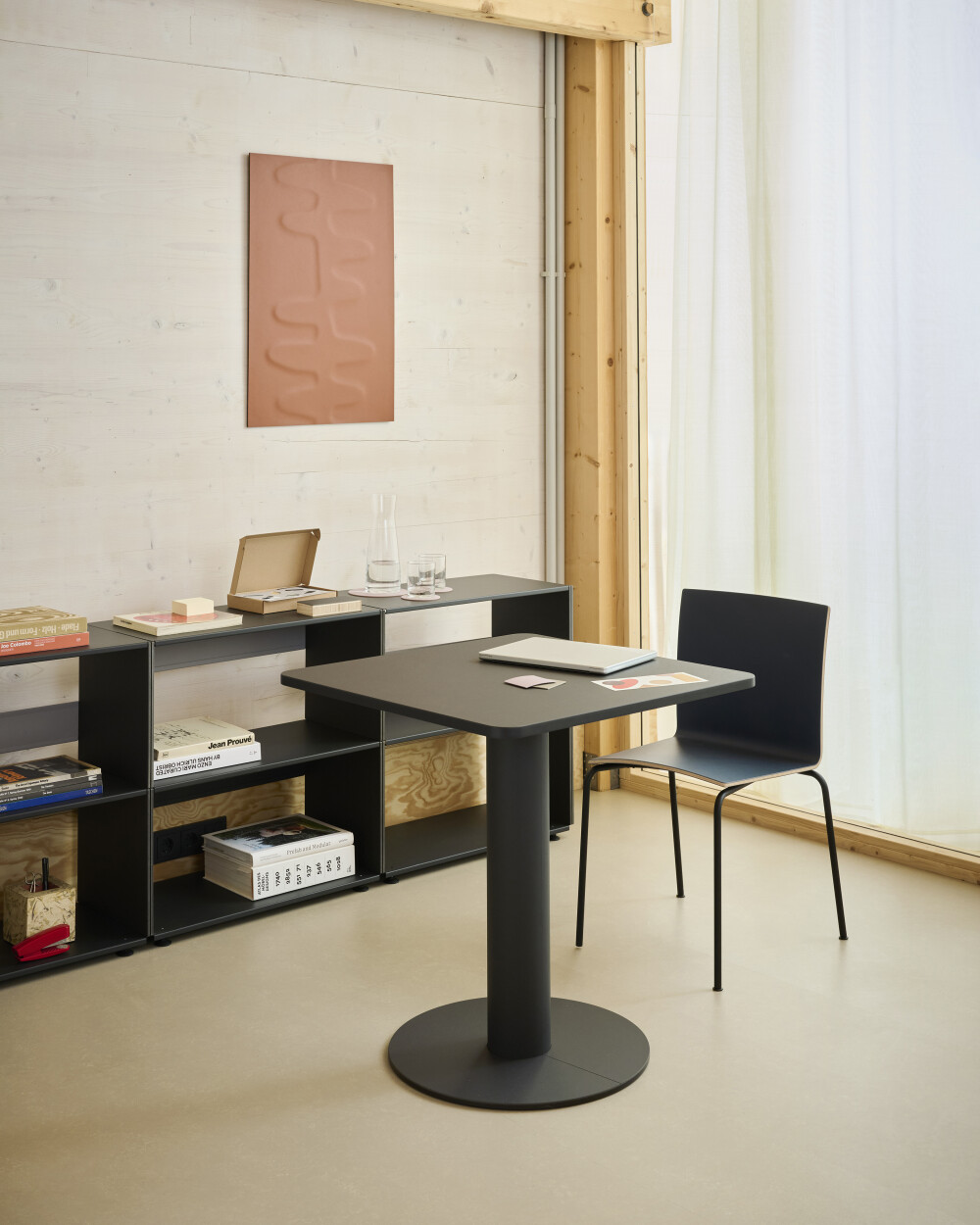 Square SPOT Bistro Table with linoleum surface used as a compact desk in a home office workspace.
