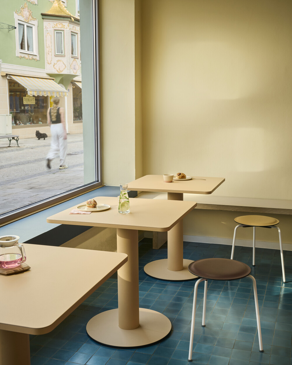 Compact SPOT Bistro Tables with squared tops used as café tables.