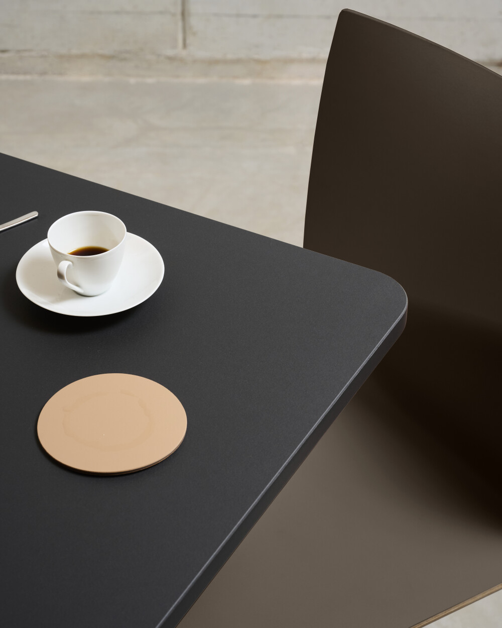Close-up of the square SPOT Bistro Table showing the linoleum tabletop and rounded corners.