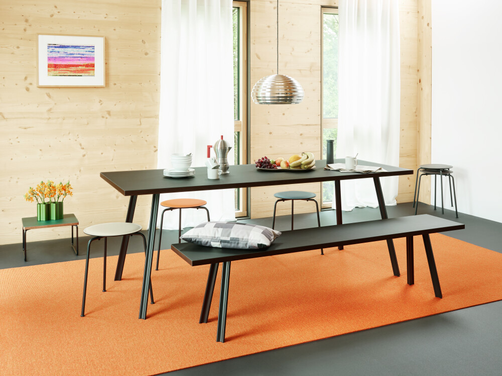 Rectangular dining tabletop with its bench lined in dark linoleum with coloured edge mounted on Beam aluminium legs by Daniel Lorch for FAUST Linoleum