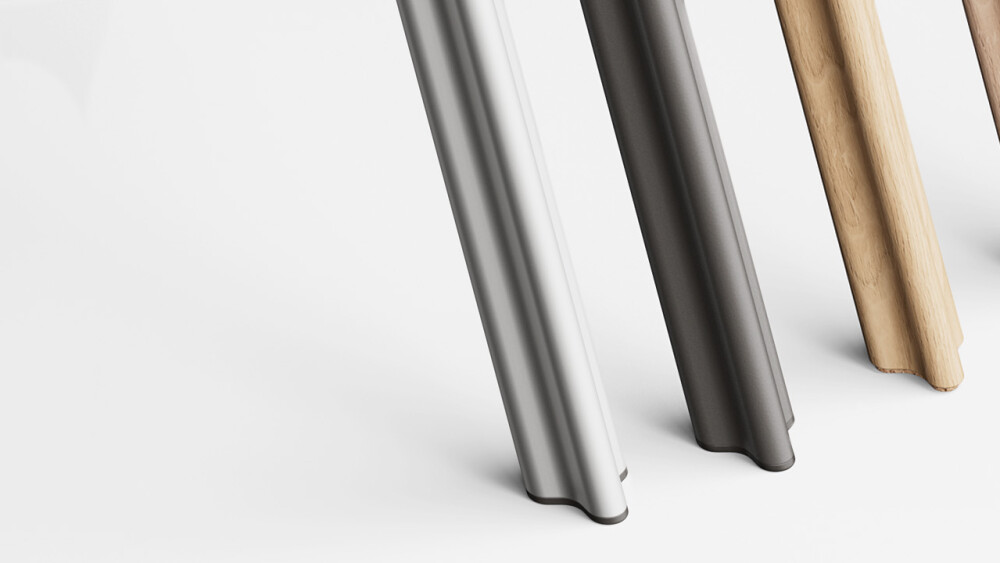 A sequence of four BEAM legs, on a white backdrop, from foreground to background: BEAM leg in matte silver anodised aluminum with plastic glides; BEAM leg in black powder-coated aluminum with plastic glides; BEAM leg in solid oak wood with cork glides; BE