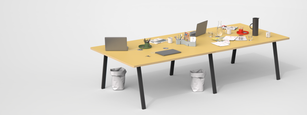 A spacious tabletop in Pure Linoleum with a wooden edge, supported by angled black metal DIN legs designed by Michel Charlot. It accommodates four workstations, equipped with cable management and featuring essential office items, creating an organised and