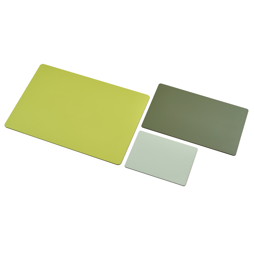 Aerial view of three linoleum table mats: 4182 Spring Green in large size, 4184 Olive in medium size, and 4183 Pistachio in mouse pad size, arranged on a neutral background.