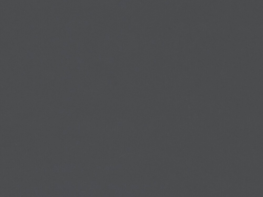 Linoleum-Oberfläche von Faust in Basalt – dunkler, matter Grauton mit feiner Struktur, gezeigt als Nahaufnahme einer Tischplatte.