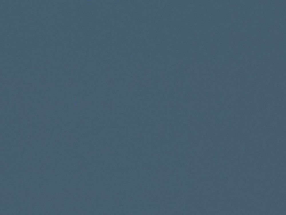 Linoleum-Oberfläche in Denim – matter, fein texturierter Belag in tiefem Jeansblau, dargestellt als Materialdetail einer Faust-Tischplatte.