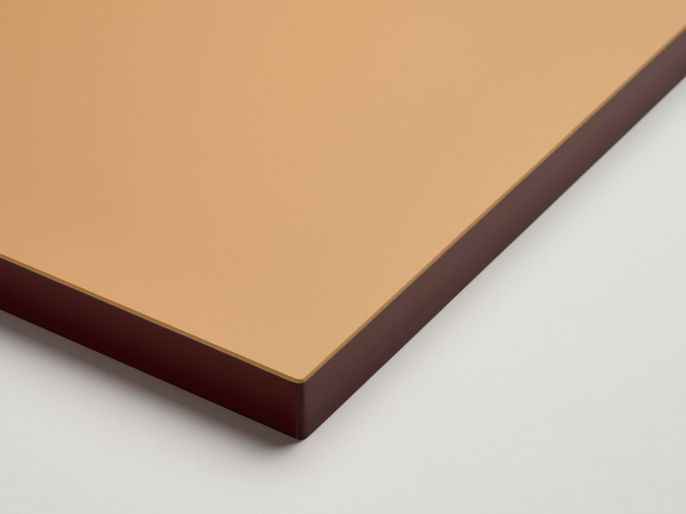 Linoleum table top from Faust in brown (Leather) with contrasting ABS edge in burgundy red - detail on a light background.