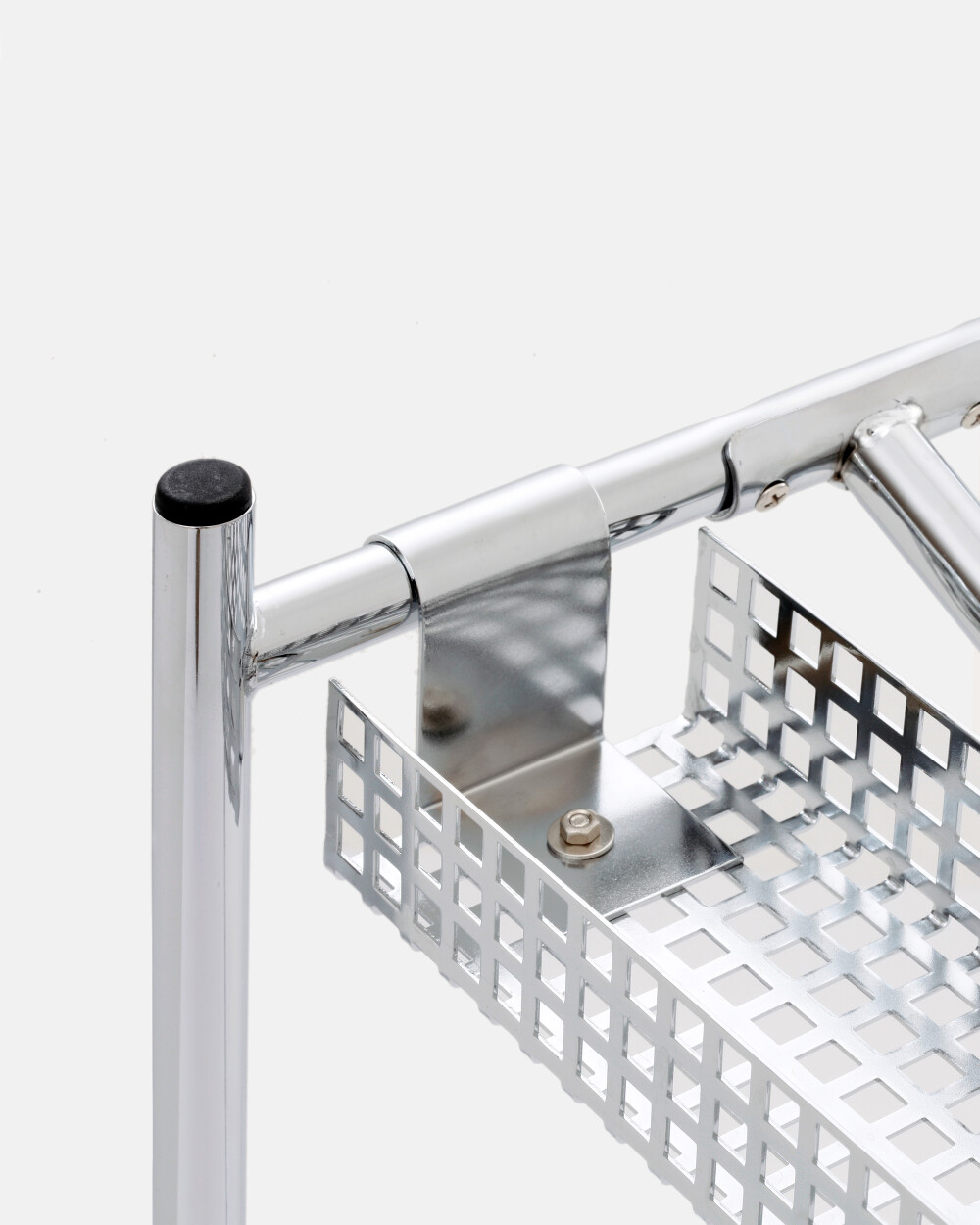 Detailed view of the metal bracket and fastening of the cable channel to the E2 table frame for secure cable routing under the tabletop.