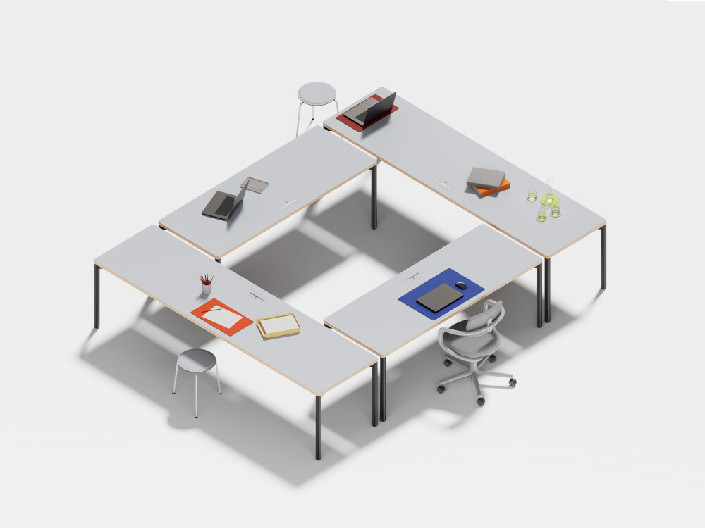 Four Outline desks by Faust with warm linoleum surfaces, each with a black frame, shown in various setups.